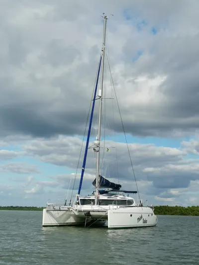Think Twice Yacht Photos Pics 2005 Fountaine Pajot Lavezzi Maestro catamaran sailing on calm waters under cloudy skies.