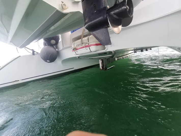 Think Twice Yacht Photos Pics 2005 Fountaine Pajot Lavezzi Maestro catamaran underside with visible propeller and calm green water.