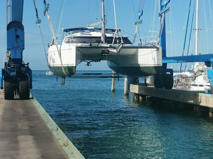 Think Twice Yacht Photos Pics 2005 Fountaine Pajot Lavezzi Maestro catamaran being lifted at a marina.