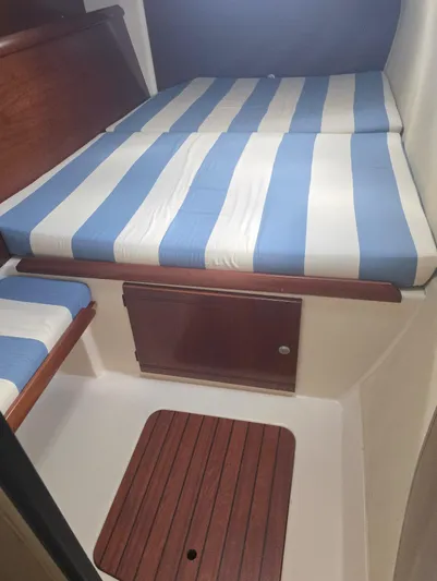 Think Twice Yacht Photos Pics 2005 Fountaine Pajot Lavezzi Maestro cabin with striped bedding and wooden flooring.