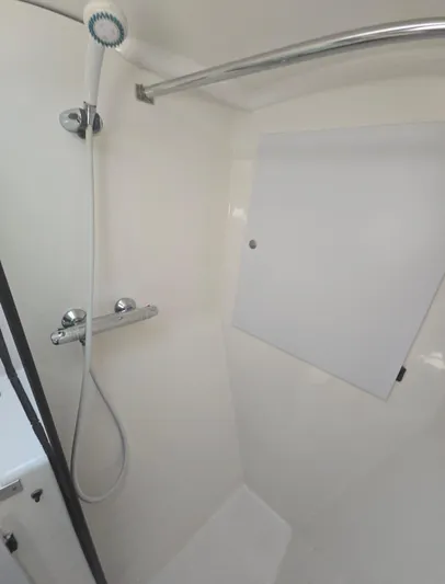 Think Twice Yacht Photos Pics Shower area in 2005 Fountaine Pajot Lavezzi Maestro catamaran, featuring sleek white design.