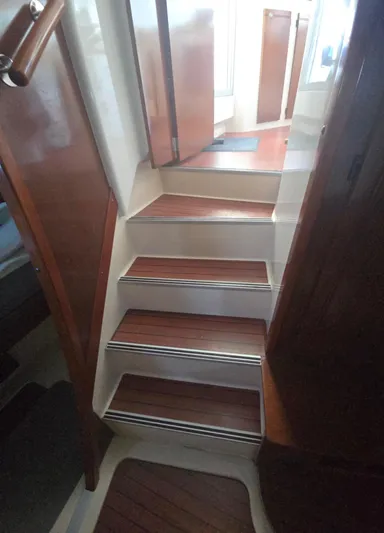 Think Twice Yacht Photos Pics Staircase inside 2005 Fountaine Pajot Lavezzi Maestro catamaran with wooden steps.