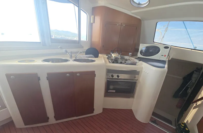 Think Twice Yacht Photos Pics 2005 Fountaine Pajot Lavezzi Maestro yacht kitchen with stove, sink, and microwave.