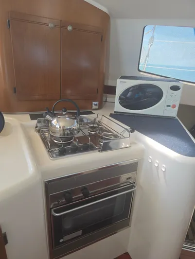 Think Twice Yacht Photos Pics 2005 Fountaine Pajot Lavezzi Maestro yacht kitchen with stove, oven, and microwave.