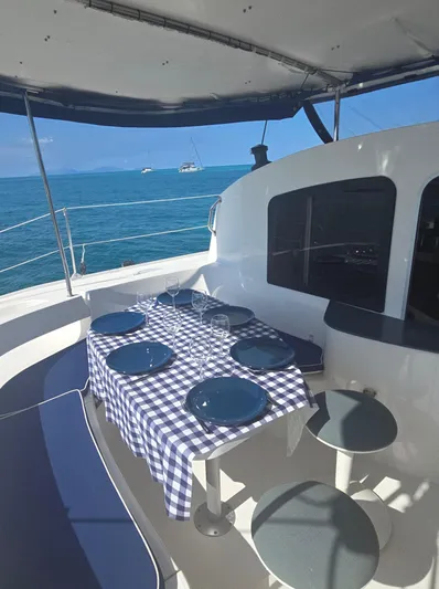 Think Twice Yacht Photos Pics 2005 Fountaine Pajot Lavezzi Maestro yacht with outdoor dining, blue sea view.