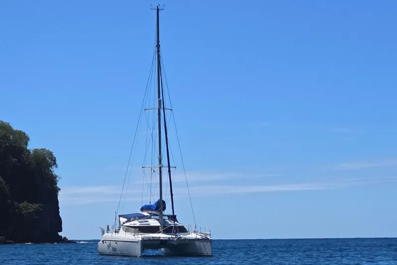 Think Twice Yacht Photos Pics 2005 Fountaine Pajot Lavezzi Maestro catamaran sailing on calm blue sea.