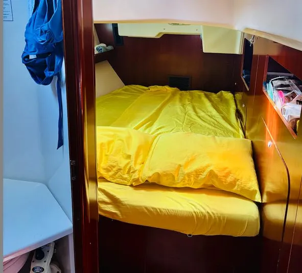 Magique 2 Yacht Photos Pics Cozy cabin interior of 2005 Beneteau Oceanis 523 with yellow bedding.