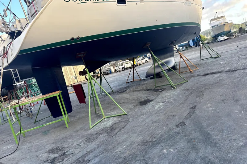 Magique 2 Yacht Photos Pics 2005 Beneteau Oceanis 523 sailboat on stands in a shipyard for maintenance.