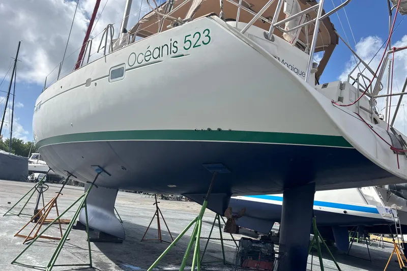 Magique 2 Yacht Photos Pics 2005 Beneteau Oceanis 523 sailboat on dry dock, supported by stands.