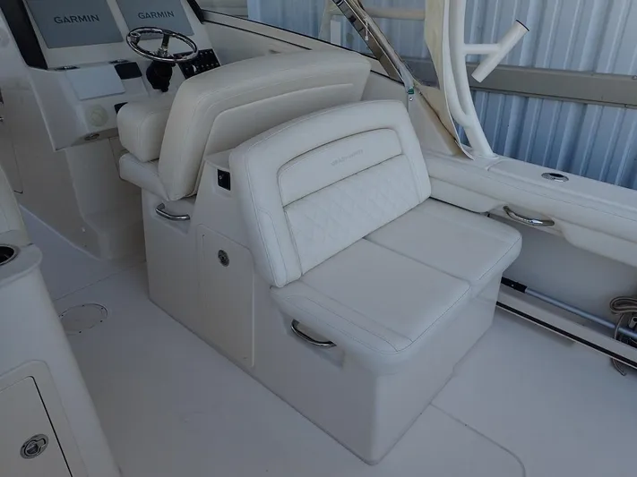 Yacht Photos Pics 2021 Grady-White Freedom 325 boat interior with white seating and Garmin controls.