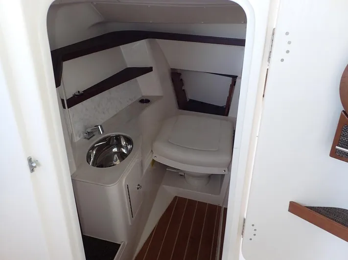  Yacht Photos Pics Interior of 2021 Grady-White Freedom 325 boat, featuring a compact bathroom with sink and toilet.