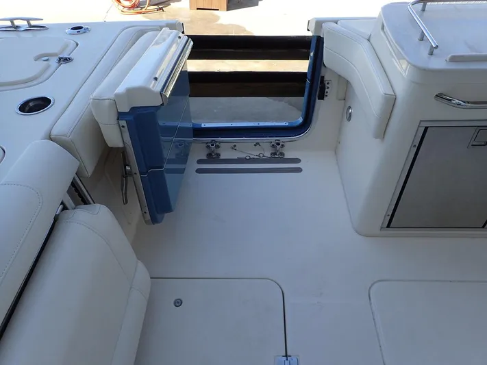  Yacht Photos Pics 2021 Grady-White Freedom 325 boat interior with open transom door and seating area.