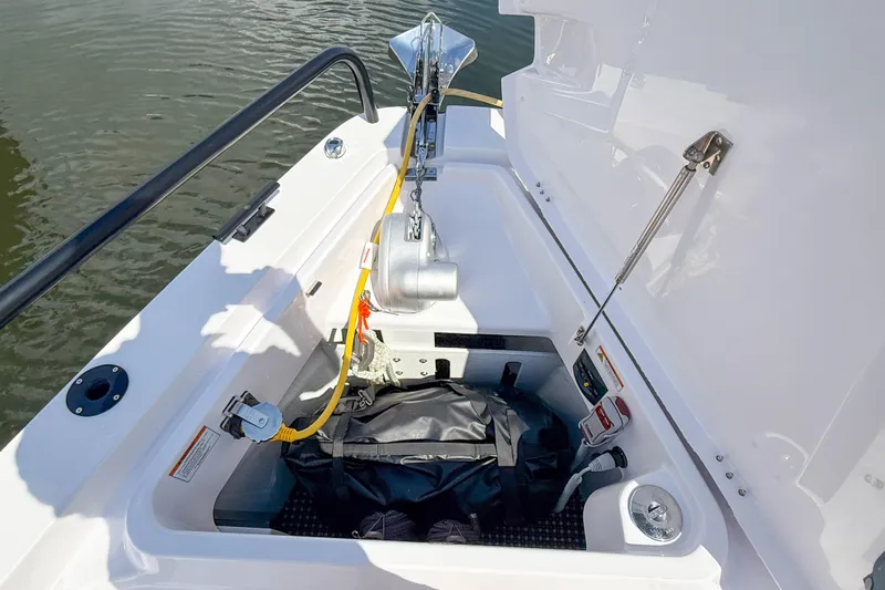 Maverick Yacht Photos Pics Anchor compartment of 2023 Axopar 37 XC AFT CABIN boat, featuring storage and equipment.