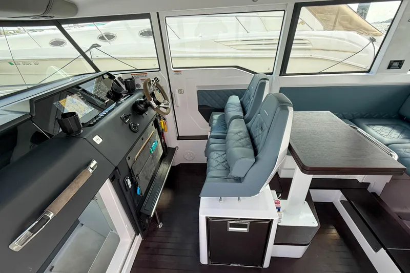 Maverick Yacht Photos Pics Interior of 2023 Axopar 37 XC AFT CABIN with modern seating and navigation controls.