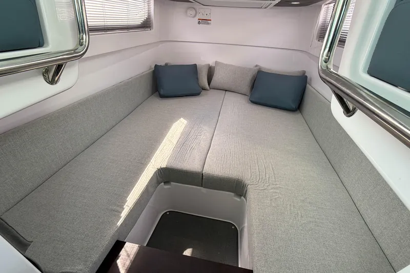 Maverick Yacht Photos Pics 2023 Axopar 37 XC AFT CABIN interior with gray seating and blue cushions.