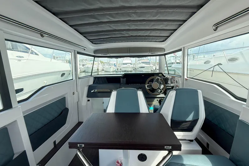 Maverick Yacht Photos Pics Interior of 2023 Axopar 37 XC AFT CABIN, featuring modern seating and helm.