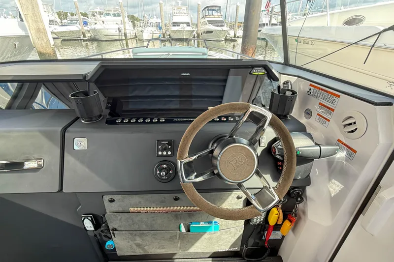 Maverick Yacht Photos Pics 2023 Axopar 37 XC AFT CABIN helm with modern controls and steering wheel.