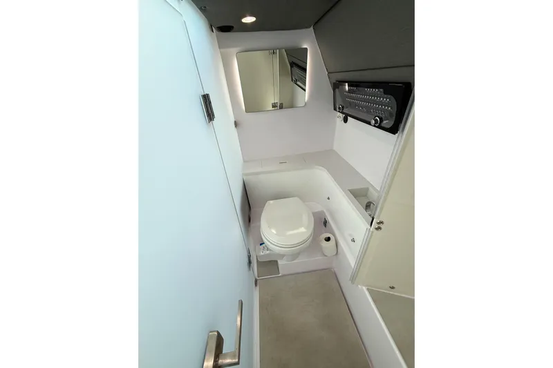 Maverick Yacht Photos Pics 2023 Axopar 37 XC AFT CABIN bathroom with modern fixtures and compact design.