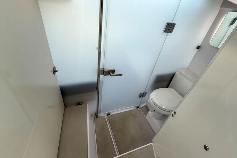 Maverick Yacht Photos Pics Bathroom interior of 2023 Axopar 37 XC AFT CABIN, featuring modern design and fixtures.