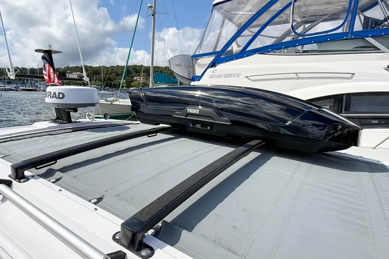Maverick Yacht Photos Pics 2023 Axopar 37 XC AFT CABIN with roof cargo box, docked at marina.