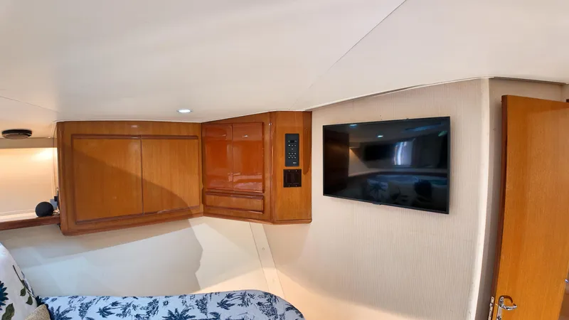  Yacht Photos Pics Interior of 1998 Viking 47 Convertible yacht with wooden cabinets and mounted TV.