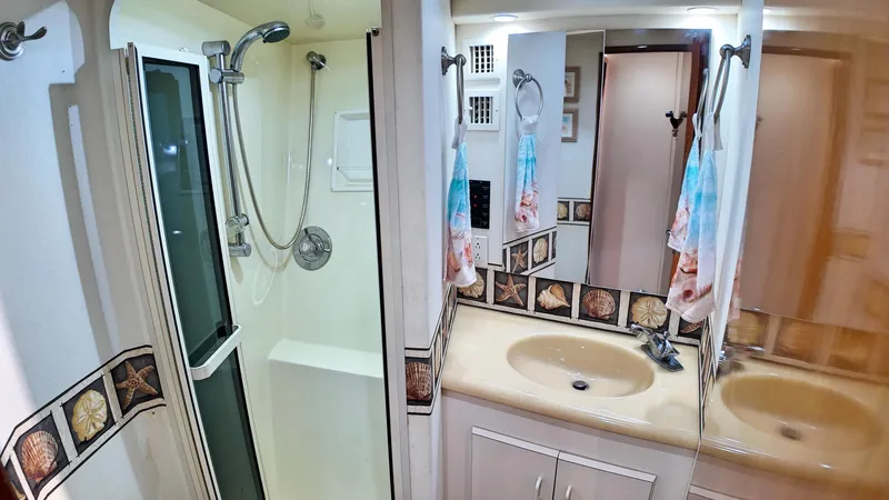  Yacht Photos Pics Bathroom interior of 1998 Viking 47 Convertible yacht with shower and sink.