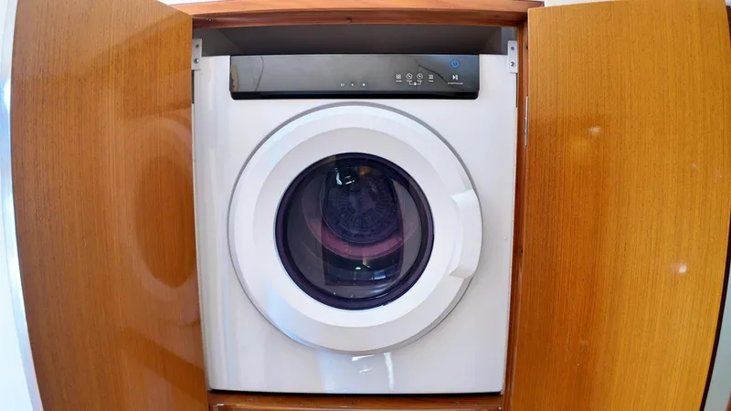  Yacht Photos Pics Front-loading washing machine in wooden cabinet on a 1998 Viking 47 Convertible yacht.