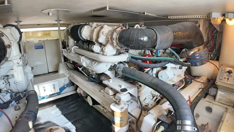  Yacht Photos Pics Engine room of a 1998 Viking 47 Convertible yacht, showcasing mechanical components and systems.