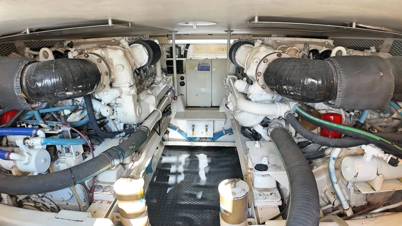  Yacht Photos Pics Engine room of a 1998 Viking 47 Convertible yacht, showcasing dual engines and mechanical components.