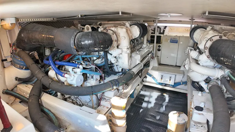  Yacht Photos Pics Engine room of a 1998 Viking 47 Convertible yacht, showcasing dual engines and mechanical components.