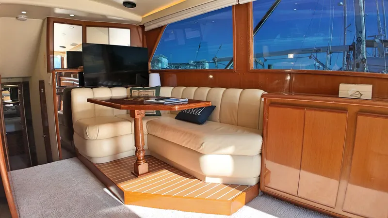  Yacht Photos Pics Luxurious interior of a 1998 Viking 47 Convertible yacht with plush seating and wooden accents.