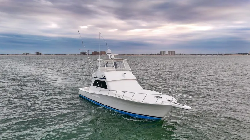  Yacht Photos Pics 1998 Viking 47 Convertible yacht on open water under cloudy sky.