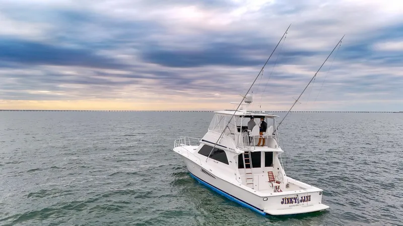  Yacht Photos Pics 1998 Viking 47 Convertible yacht on open water under a cloudy sky.