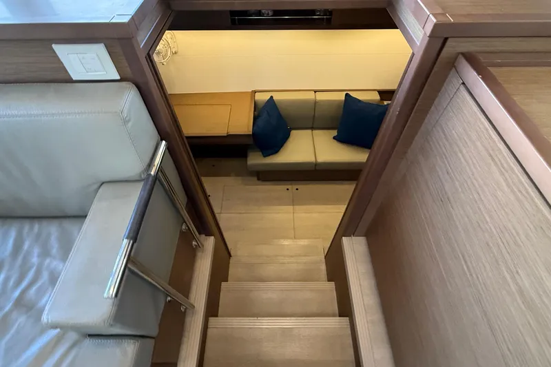  Yacht Photos Pics Interior view of 2019 Lagoon 450 yacht, featuring stairs and cozy seating area.