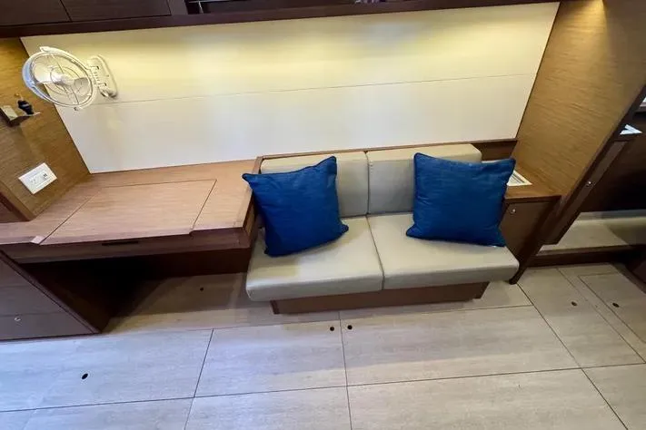  Yacht Photos Pics Interior of 2019 Lagoon 450 yacht with beige sofa and blue cushions.