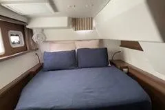  Yacht Photos Pics Luxurious cabin interior of 2019 Lagoon 450 yacht with cozy bedding.