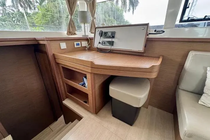  Yacht Photos Pics Interior of 2019 Lagoon 450 yacht with wooden desk and seating area.