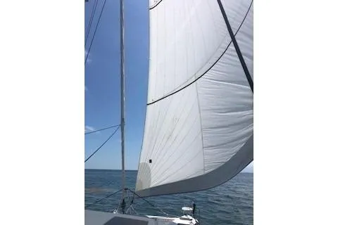  Yacht Photos Pics Sailing on a 2019 Lagoon 450 catamaran with white sails against a clear blue sky.