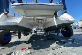  Yacht Photos Pics 2019 Lagoon 450 catamaran on a lift, showcasing its hull and undercarriage.