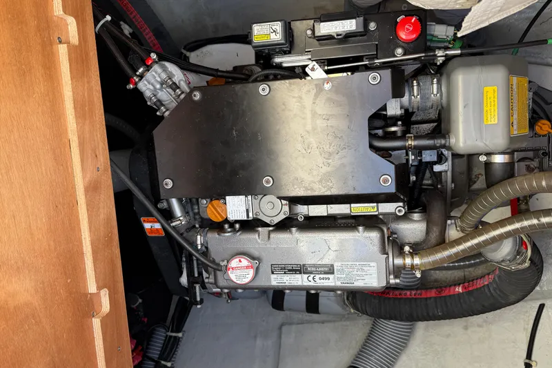  Yacht Photos Pics Engine compartment of a 2019 Lagoon 450 catamaran, showcasing mechanical components and hoses.