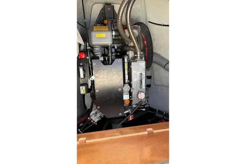  Yacht Photos Pics Engine compartment of a 2019 Lagoon 450 catamaran, showcasing mechanical components and hoses.