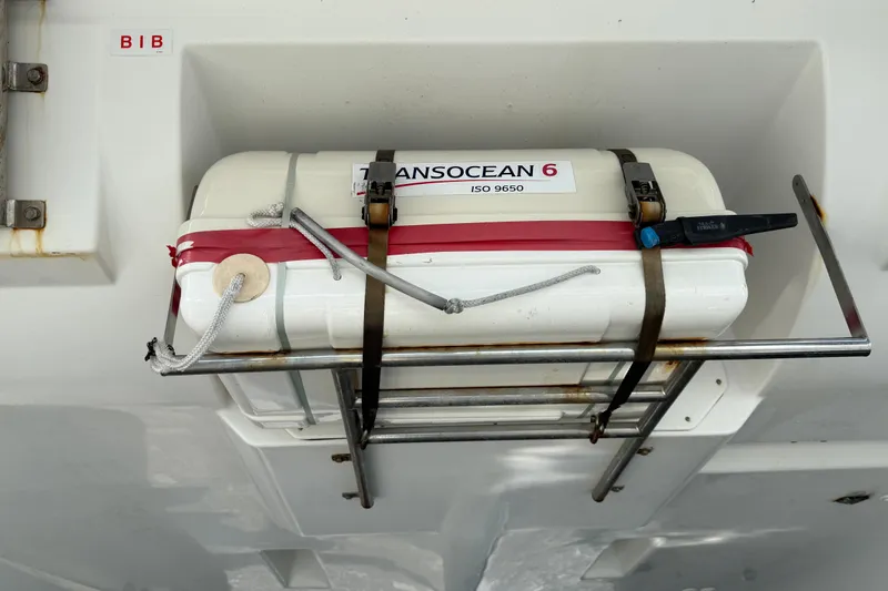  Yacht Photos Pics Life raft on 2019 Lagoon 450 catamaran, secured with straps and labeled "Transocean 6."