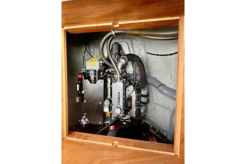  Yacht Photos Pics Engine compartment of a 2019 Lagoon 450 catamaran, showcasing mechanical components and wiring.