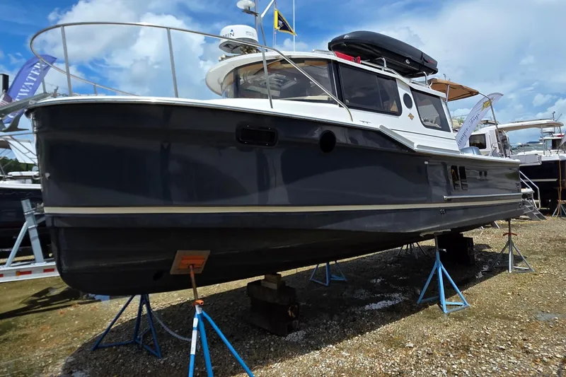 Seamore Yacht Photos Pics 2020 Ranger Tugs R27LE boat on stands, displayed outdoors under a blue sky.