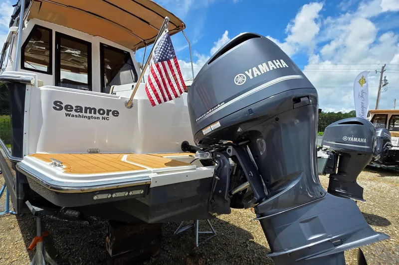 Seamore Yacht Photos Pics 2020 Ranger Tugs R27LE boat with Yamaha outboard motor, American flag, and "Seamore" name.
