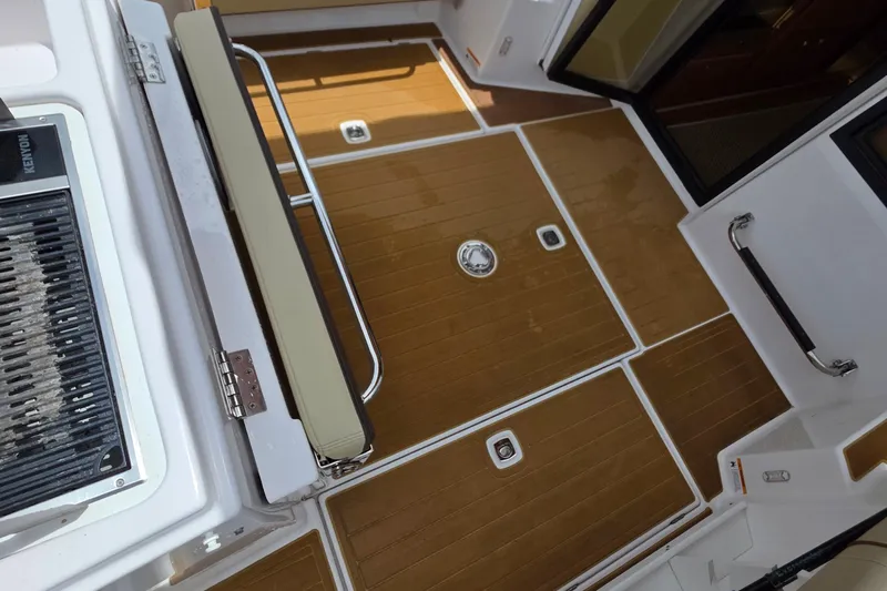 Seamore Yacht Photos Pics 2020 Ranger Tugs R27LE boat deck with teak flooring and stainless steel fittings.