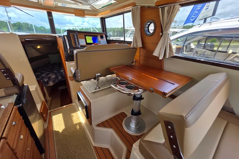 Seamore Yacht Photos Pics Interior of 2020 Ranger Tugs R27LE boat with wood accents and navigation equipment.