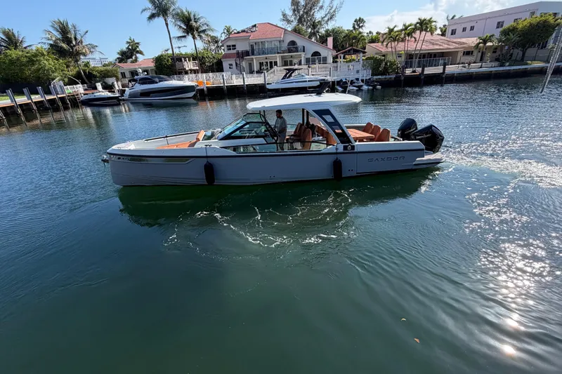  Yacht Photos Pics 2024 Saxdor 320 GTO boat cruising in a scenic waterfront setting.
