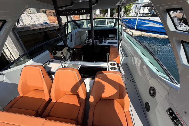  Yacht Photos Pics 2024 Saxdor 320 GTO boat interior with orange seats and modern dashboard.