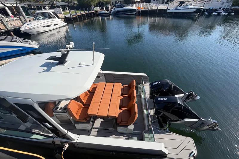  Yacht Photos Pics 2024 Saxdor 320 GTO boat docked, featuring twin engines and orange seating.